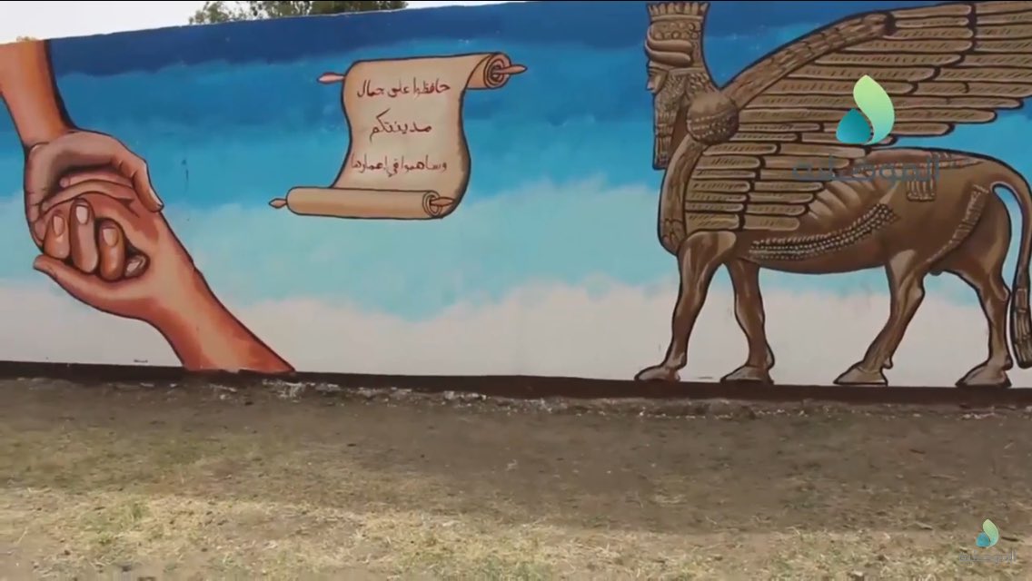 Volunteers paint over IS murals in Sumer neighborhood, East Mosul  