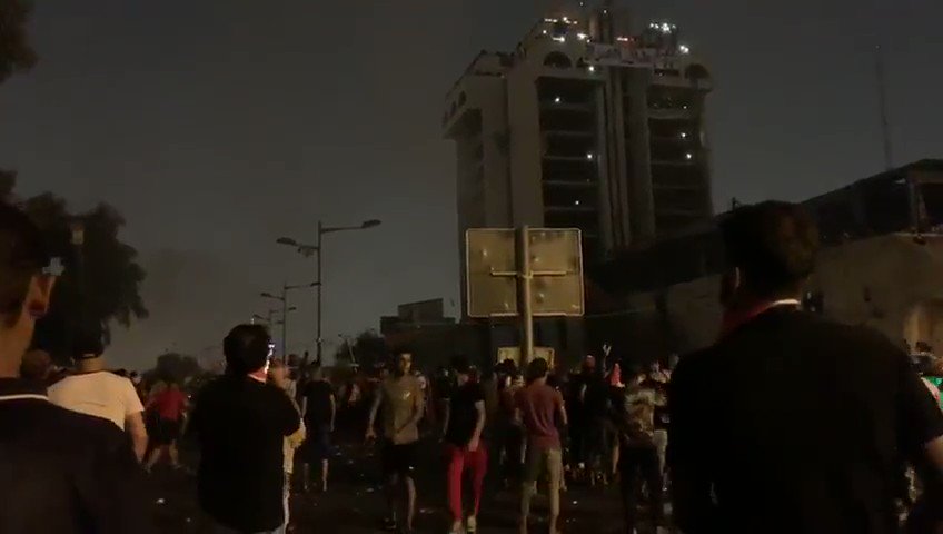 Iraqi security forces launching multiple gas canisters towards protesters,  Tahrir square, Baghdad
