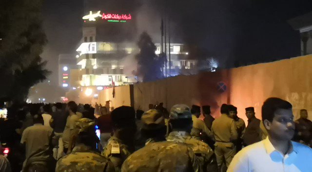 Dozens of Iraqi demonstrators have attempted to storm the Iranian consulate in Karbala, lowering the flag and burning part of the outer wall 