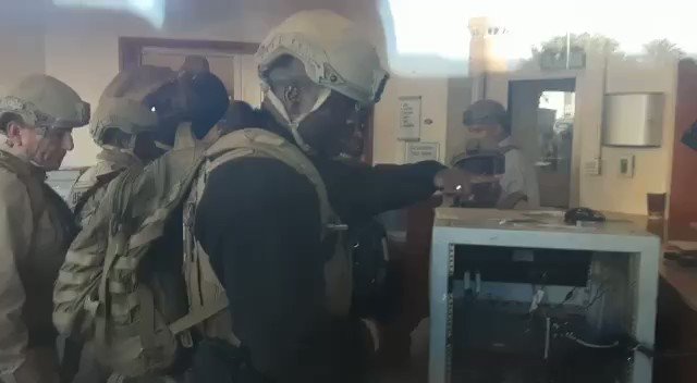 Hezbollah protesters filming U.S. Embassy protection forces through glass window