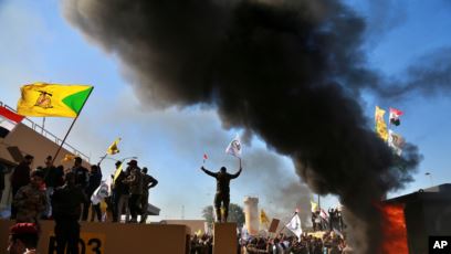 Pro-Hezbollah protesters set fire to the outer wall of the US embassy in the Green Zone in Baghdad