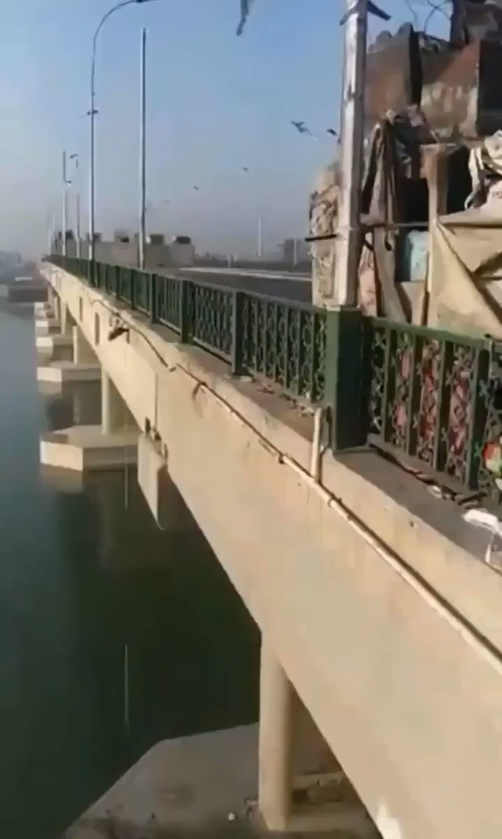 Near Jumjuriya bridge across the Green Zone, a civilian curses Qassem Suliemani. Member of Riot Police responds the blood of the dead (in reference to killed Iraqi protesters) didn't go in vain
