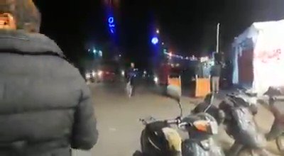 Protesters remove a large photo of Qassem Soleimani hanged at a public area in Karbala and tear it down. 