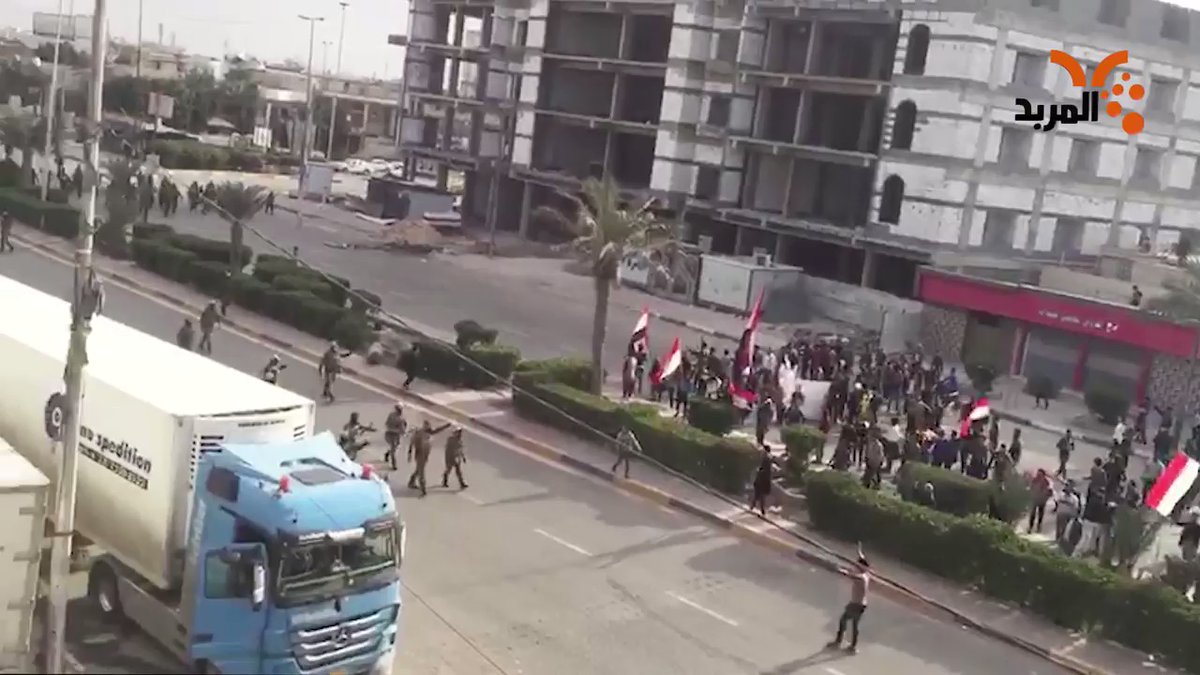 A security force pursues and disperses a march heading to Basra's Al-Mubarrad sit-in square