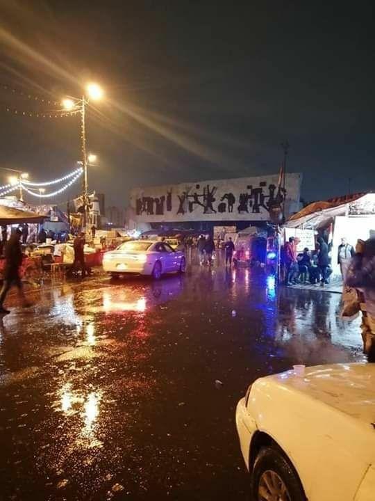 Demonstrations in Tahrir Square, central Baghdad, under rain showers