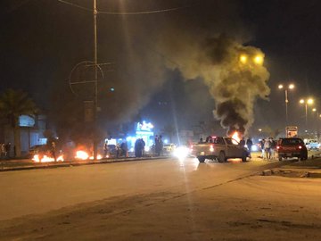 Protesters blocked the Airport Street in Najaf, southern Iraq, with burning tires
