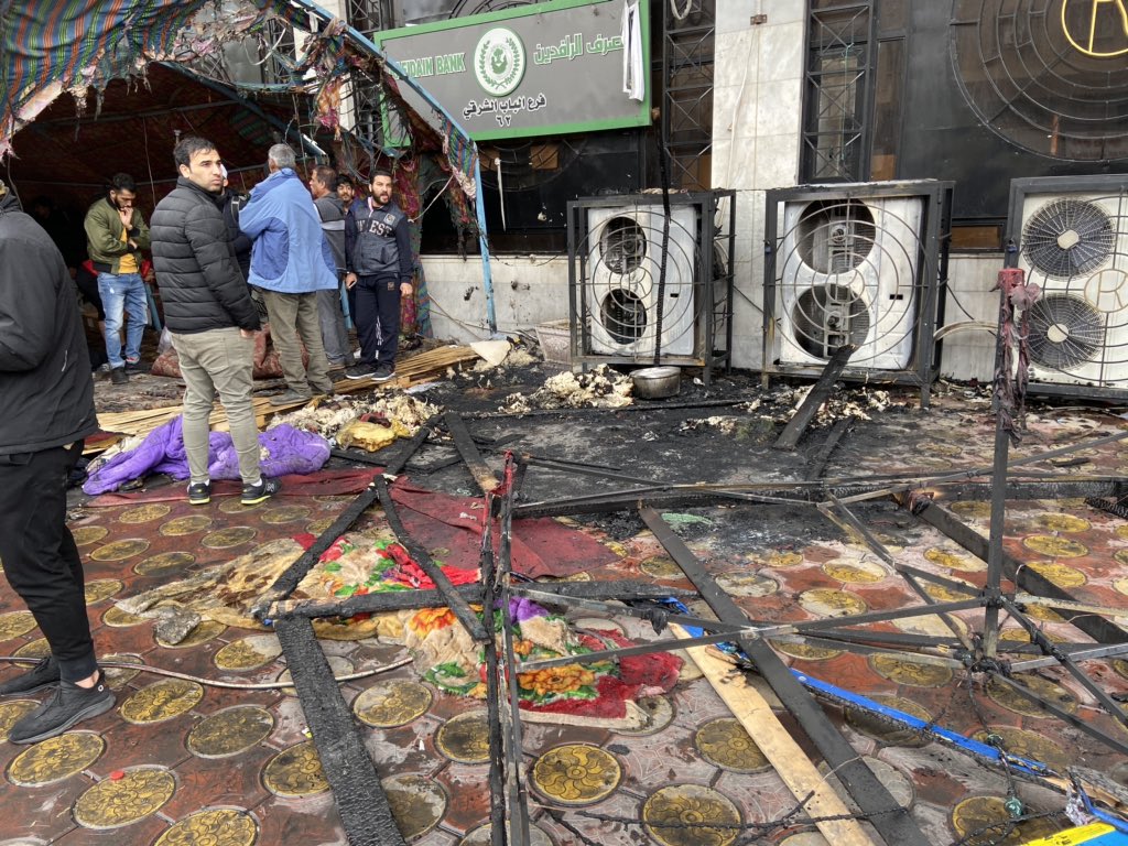 Riot police set fire to tents outside Rafidan Bank, it's about 100 meters from Tahrir Square. They have now pulled back. 