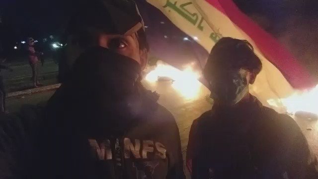 Protesters block the Najaf International Airport road in Najaf, southern Iraq