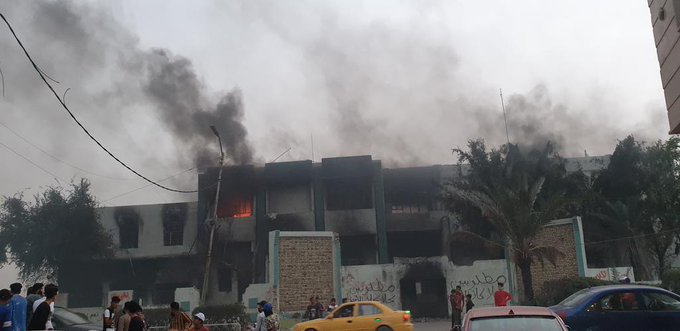 Protesters burn the headquarters of the Badr militia in the city of Nasiriyah in southern Iraq