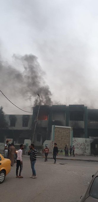 Protesters burn the headquarters of the Badr militia in the city of Nasiriyah in southern Iraq